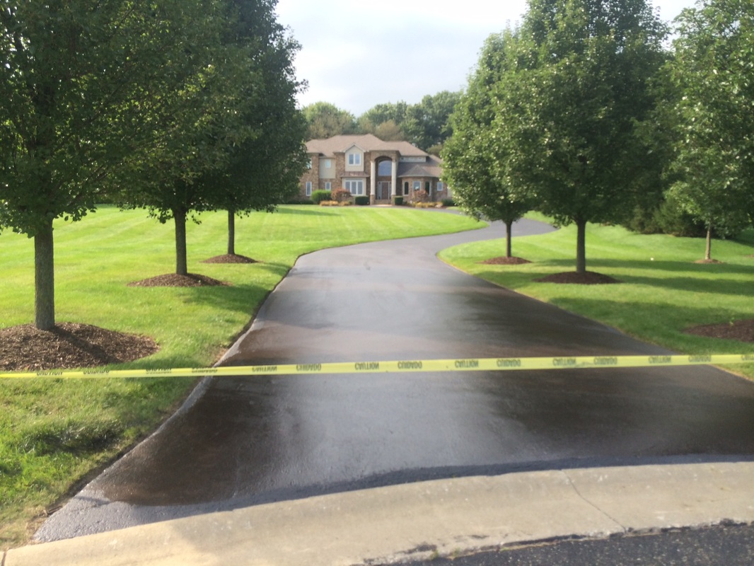 Freshly paved curved driveway leading to a residential home in Massillon, Ohio